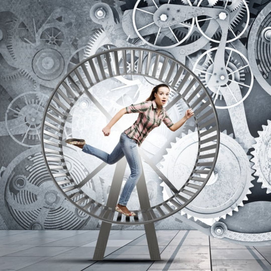 Stressed woman running on a hamster wheel with image of gears in the background