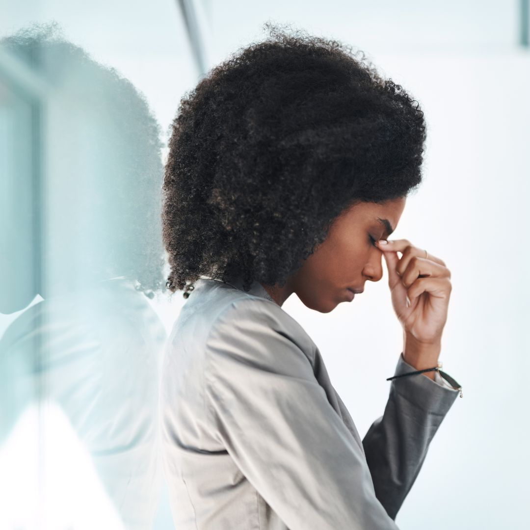 Stressed professional woman with her hand against her head