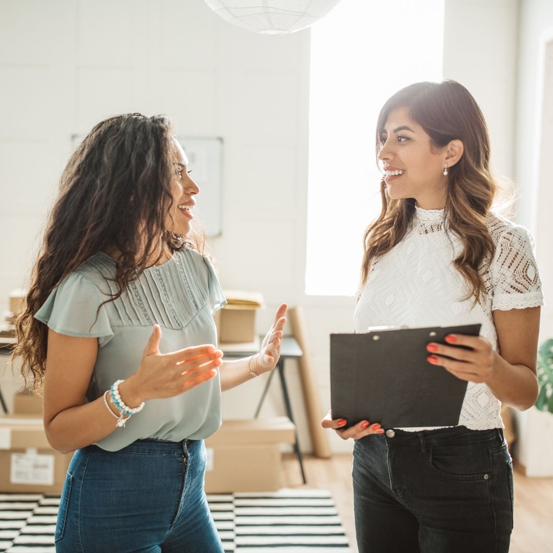 Two professional women discussing a project