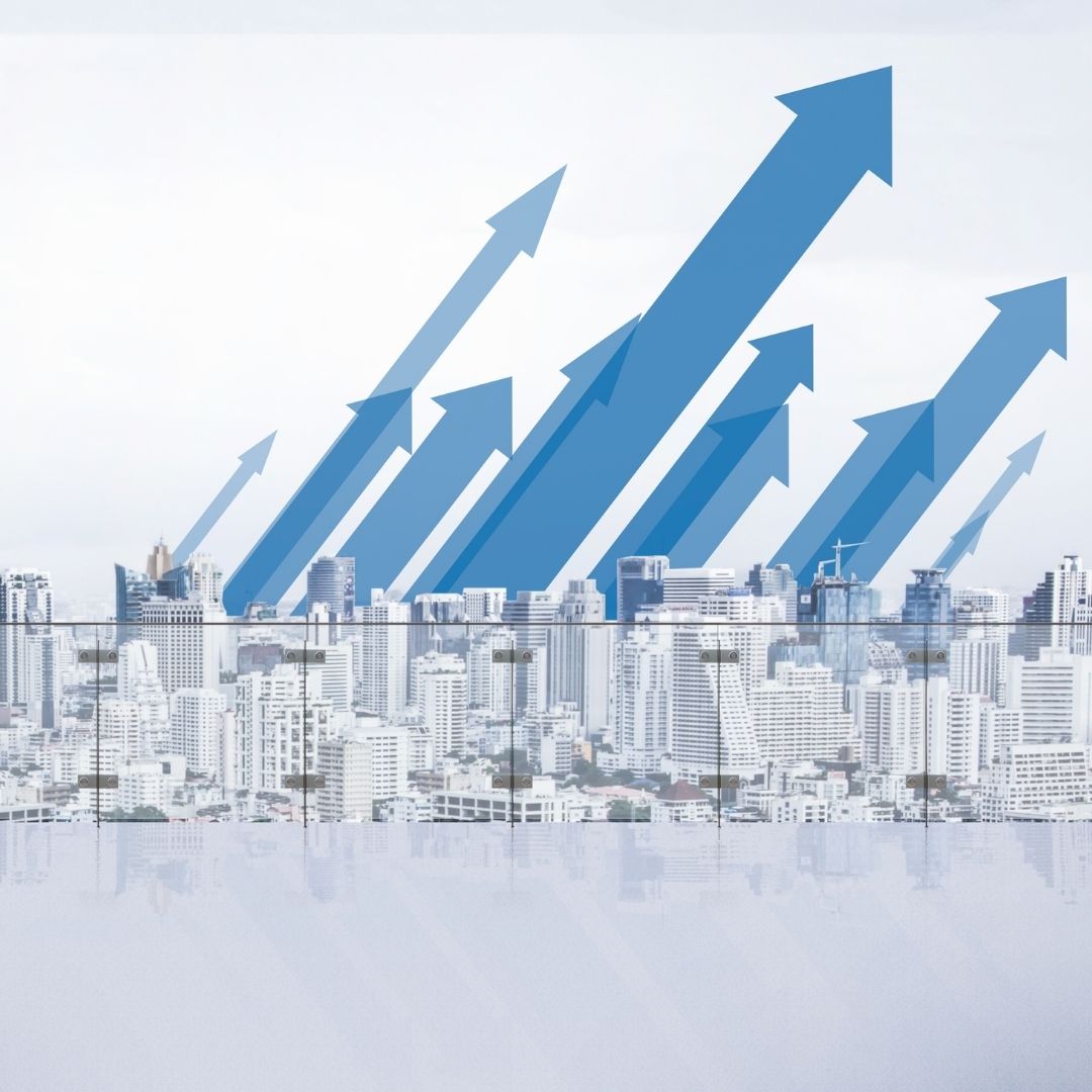 A city skyline with blue arrows pointing up