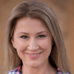 Coach Viktoria smiling, showcasing her approachable demeanor, representing Upleveling Your Business's commitment to personalized coaching and support for entrepreneurs.