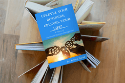 Book titled "Uplevel Your Business, Uplevel Your Life" by Kristen David, displayed on an open book stack, emphasizing successful business management and growth strategies.