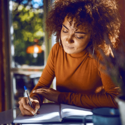 business woman writing out a business plan