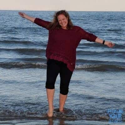 image of Kristen David walking along the beach