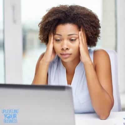stressed businesswoman at a laptop