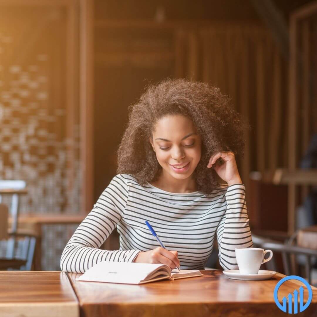 female business owner with a cup of coffee revising business plan