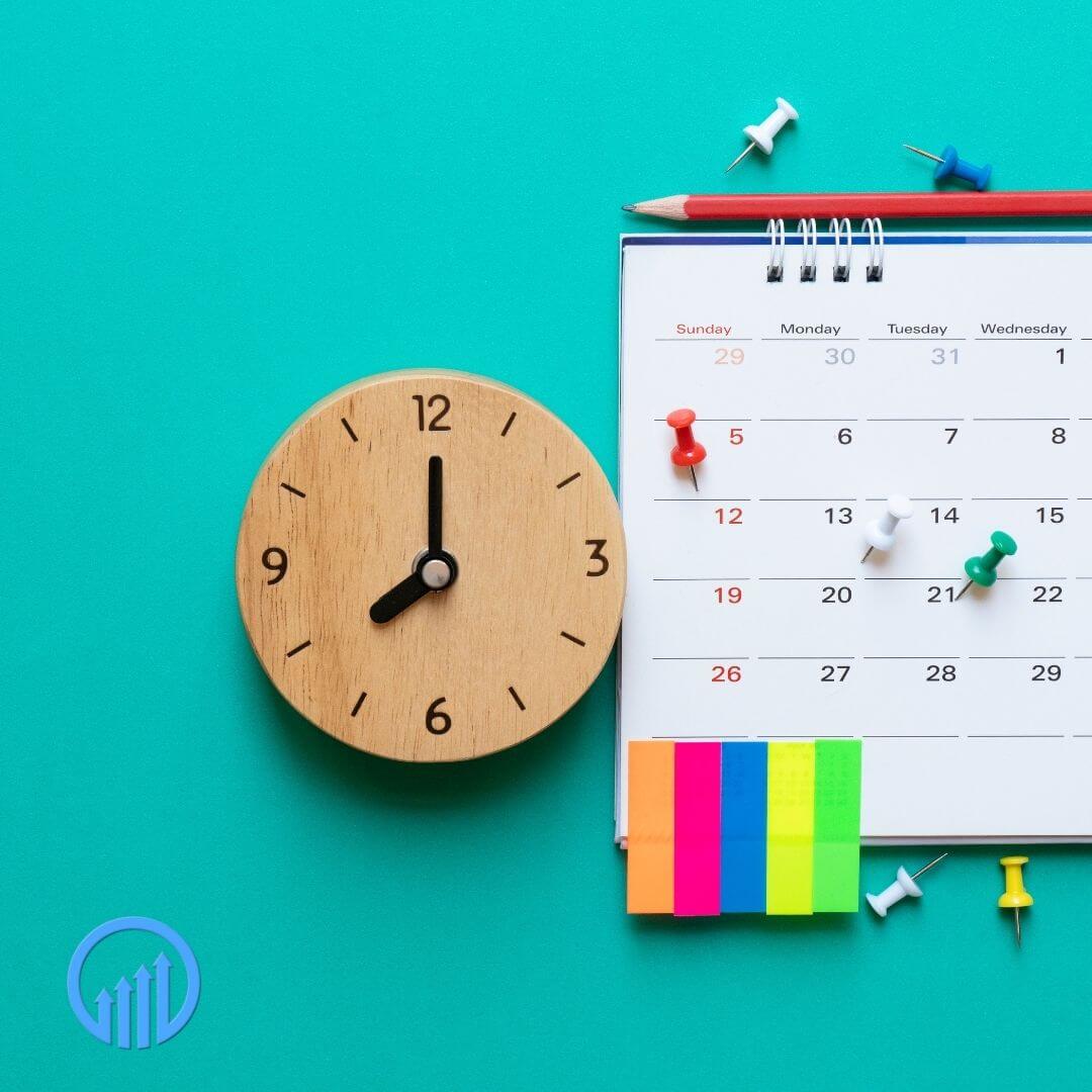 Clock and calendar on teal background, symbolizing time management and organization for effective marketing strategies.