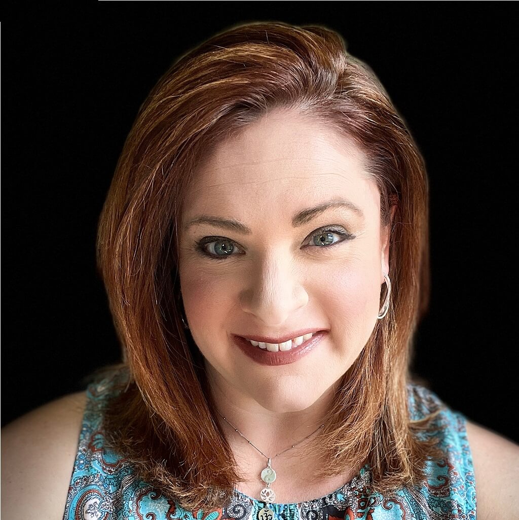 Jaclyn DuBois-Zolnik, systems coach, smiling portrait with vibrant top, emphasizing her passion for productivity and team empowerment.