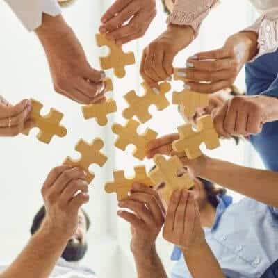 Hands bulding a puzzle