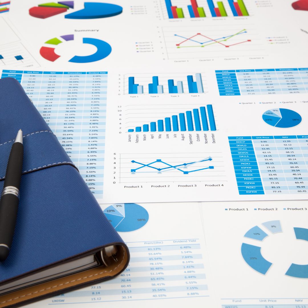 blue and white financial reports next to a blue folder
