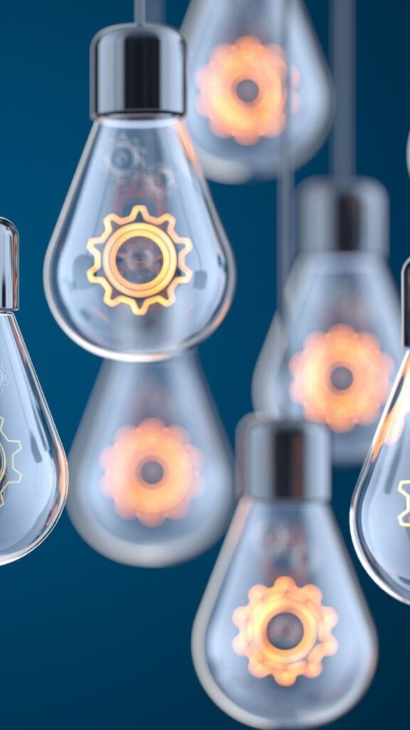Hanging light bulbs with gear designs, symbolizing innovative ideas and effective processes, relevant to the 'Termination Clinic' mini-workshop on refining termination strategies.