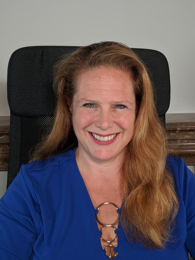 Kristen David, Founder and CEO of Upleveling Your Business, smiling in a blue top, emphasizing her role in empowering entrepreneurs through effective delegation and executive support.