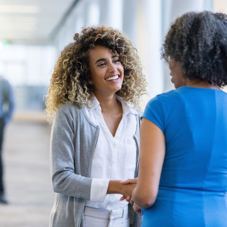 a woman in management welcoming a new hire