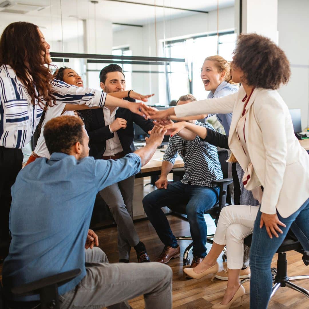 A diverse small business team celebrating a win