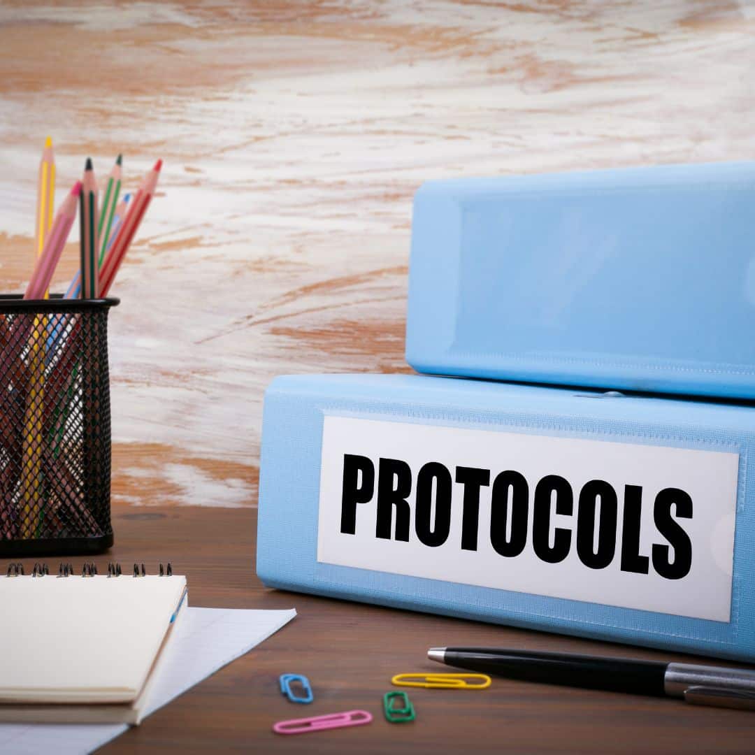 binders of small business protocols laying on a desk
