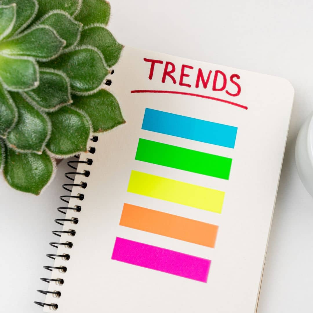 A notebook with the word "trends" and brightly colored highlights