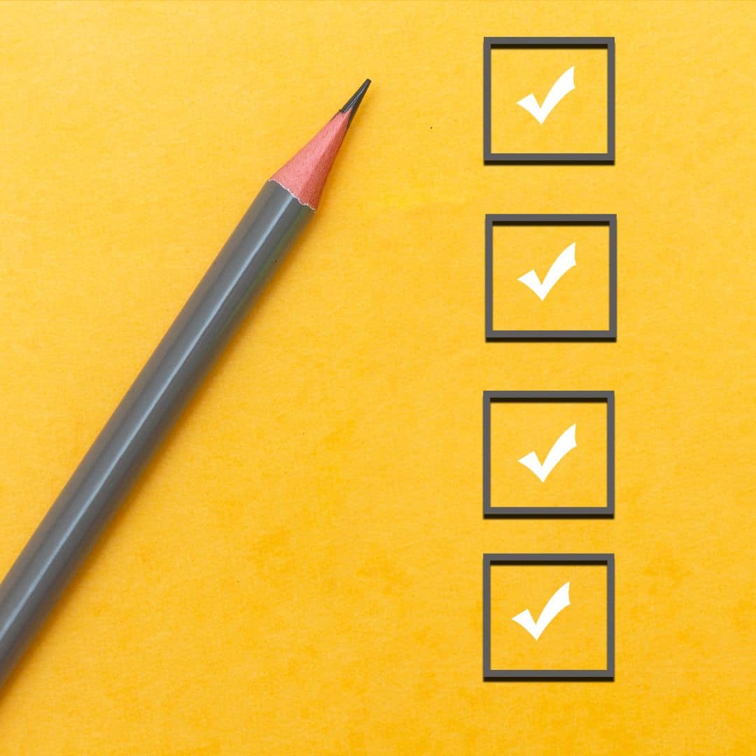 A checklist with gray boxes on a yellow background next to a gray pencil.