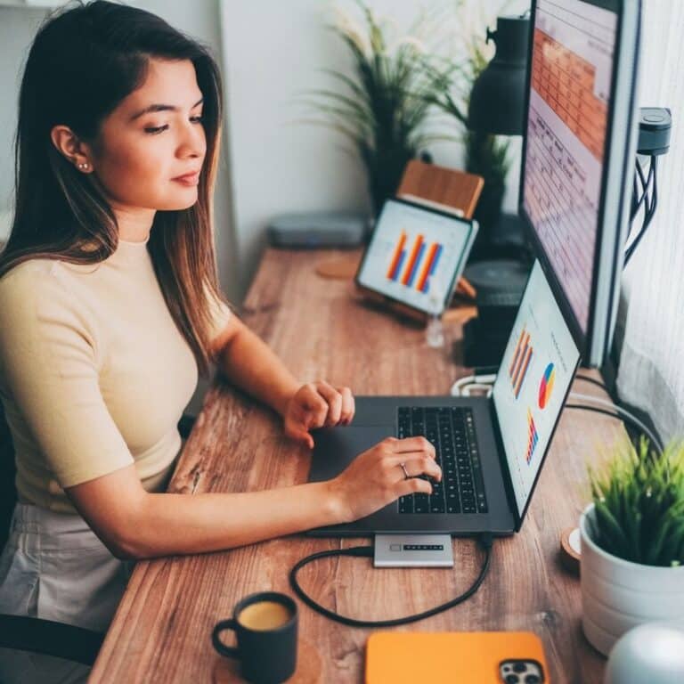 An executive assistant working at her computer with an additional screen.