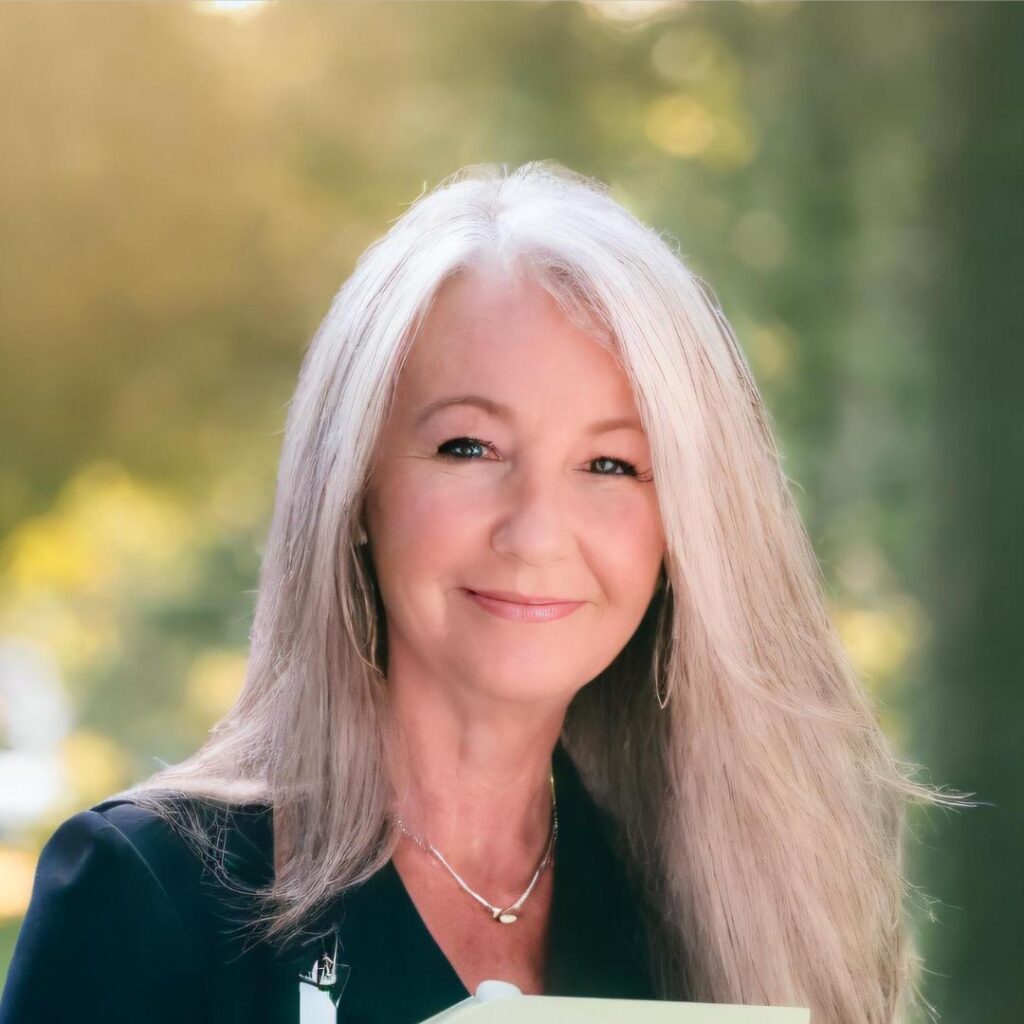 Laura Lee Sparks, marketing coach, smiling in a professional setting, showcasing her expertise in legal marketing for estate and elder law attorneys.