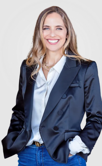 Elise, smiling confidently in a black blazer and white blouse, representing leadership and empowerment for law firm owners in the Upleveling Your Business workshop.