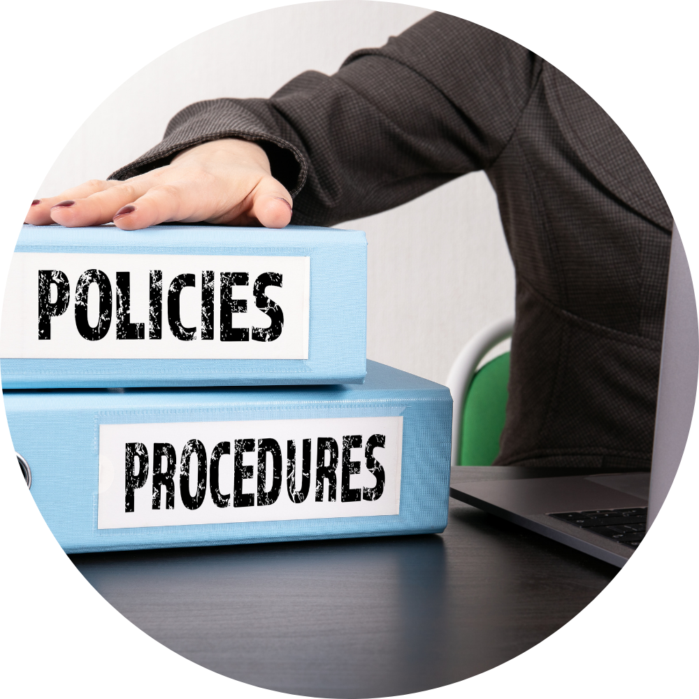 Policies and Procedures manual with blue binders on a desk, emphasizing structured business systems for sales teams.