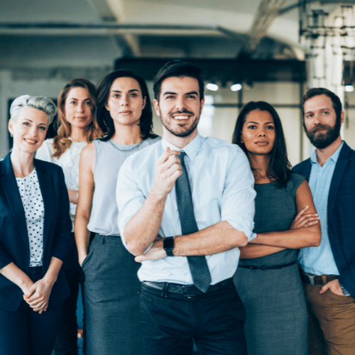 Group of diverse professionals smiling confidently, representing a strong team for the Hiring and Onboarding Boot Camp, aimed at enhancing business hiring and onboarding processes.