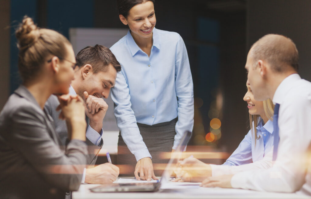 Team collaboration in a business meeting, discussing strategies for 2025 marketing trends, with a focus on systemizing processes and generating leads.