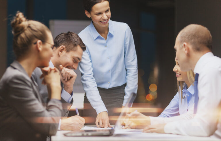 Business team collaborating in a meeting, discussing strategies with a focus on teamwork and productivity.