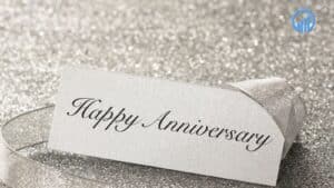 Happy Anniversary card on a glittery background, symbolizing celebration and recognition in a business context.